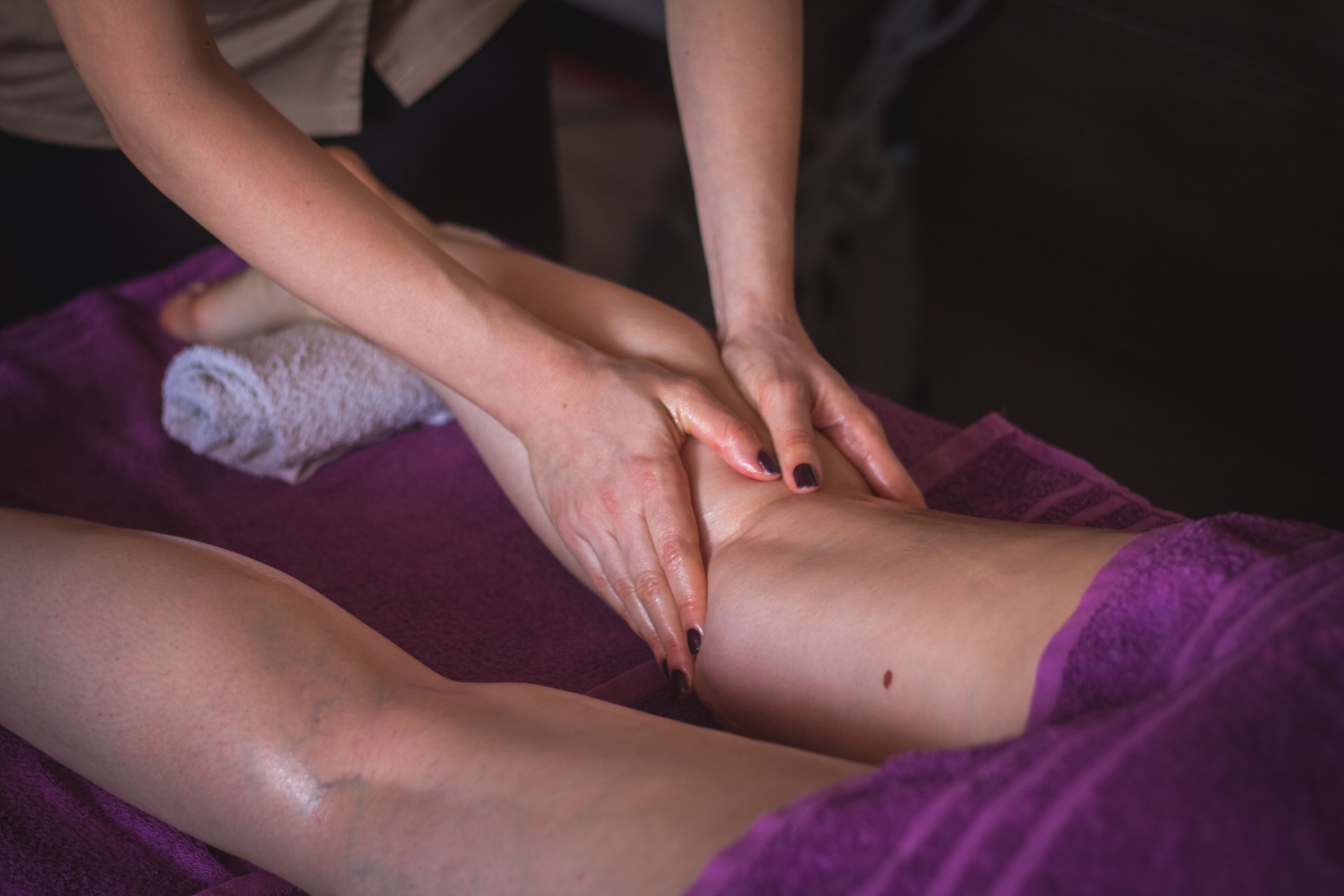 Therapist massaging human calf muscle